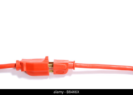 A 100 foot orange extension cord coiled up with a three way splitter Stock Photo