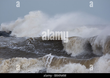 High tides - breaking waves on the North Norfolk coastline Stock Photo