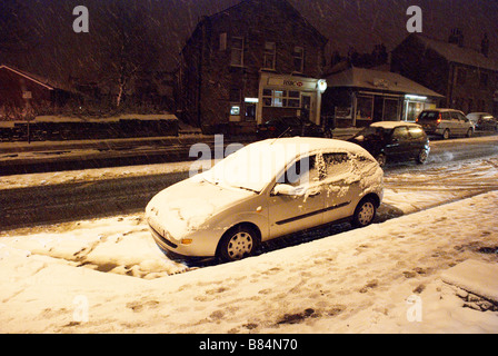 Parked car (Ford Focus) in a snow storm on New Hey Road, Marsh, Huddersfield Stock Photo