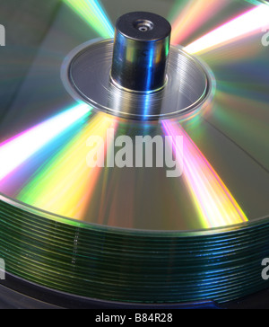 stack of CD's on a spindle lit with red and blue studio lighting Stock Photo