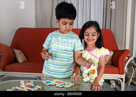 Young children solving a picture puzzle Stock Photo