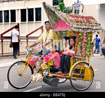 Malacca Malaysia  flower flowers decorateted tricycles rickshaw pedicab Stock Photo