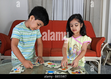 Young children solving a picture puzzle Stock Photo