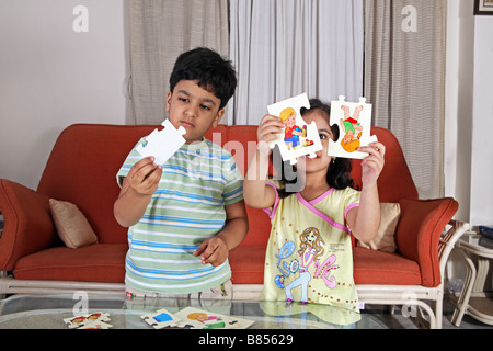 Young children solving a picture puzzle Stock Photo