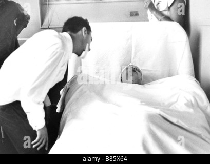 Piaf at the Rambouillet hospital after her car accident, September 7, 1958. Georges Moustaki paying her a visit Stock Photo