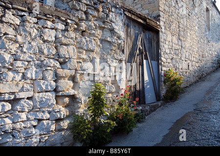 Brick house wall with doors shut in Omodhos village, Troodos mountains, South Cyprus Stock Photo
