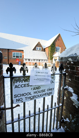 A sign on school gates warning parents of a chicken pox outbreak. Picture by Jim Holden. Stock Photo