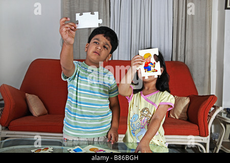 Young children solving a picture puzzle Stock Photo