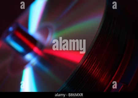 stack of CD's on a spindle lit with red and blue studio lighting Stock Photo
