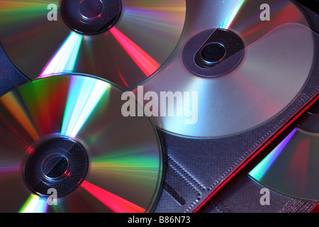 3 CD's in a wallet lit with red and blue studio lighting Stock Photo