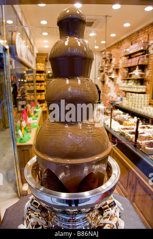 Chocolate fountain waterfall in window display at Rogier Belgian Chocolate shop near the Grand Place, Brussels. Belgium. Stock Photo