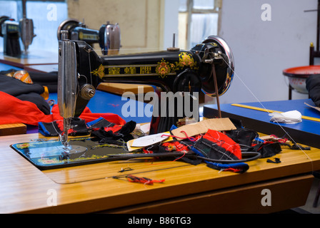 Old-school sewing machine at Tibetan school for women. They learn the craft of sewing. Stock Photo