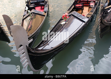 Venice Italy gondolas wait for passengers before gondoliers embark on tours of the city's famous canals. Stock Photo