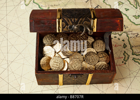 Open treasure chest with gold coins isolated on white Stock Photo