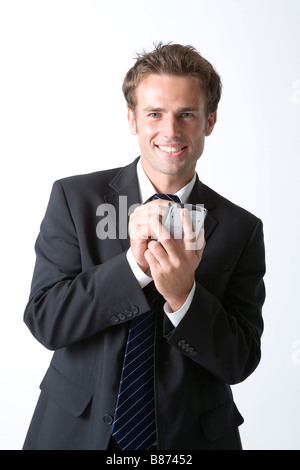 Businessman holding PDA looking at camera smiling Stock Photo