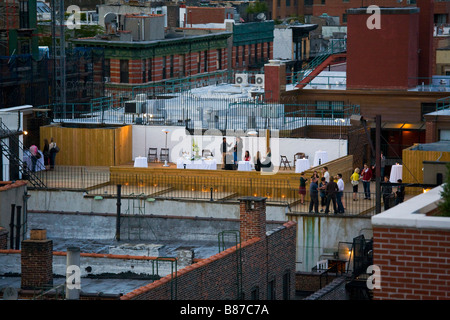 People at party on building roof Lower Manhattan New York New York Stock Photo