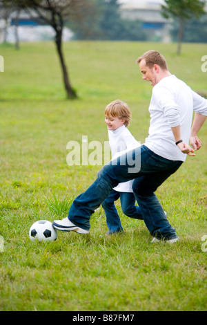 Father and son playing soccer Stock Photo