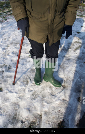 Elderly person walking on ice. Stock Photo