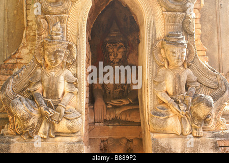Reliefs on exterior of ruined pagoda, Buddha image inside, In Dein, Inle Lake, Myanmar (Burma) Stock Photo