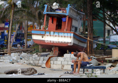 A man grieves on Patong Beach, Phuket Island, Thailand the day after the December 26, 2004 tsunami. Stock Photo