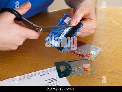 woman cutting up her credit cards Stock Photo