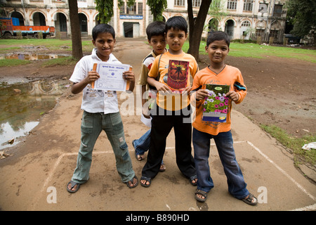 Indian boys with their school books, in the yard outside their block of flats. Mumbai, India. Stock Photo