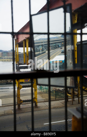 View of highway through window covered by ornate iron bars Stock Photo