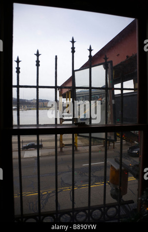 View of highway through window covered by ornate iron bars Stock Photo