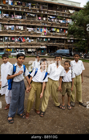 Indian school boys in the yard outside their block of flats after school. Mumbai, India. Stock Photo