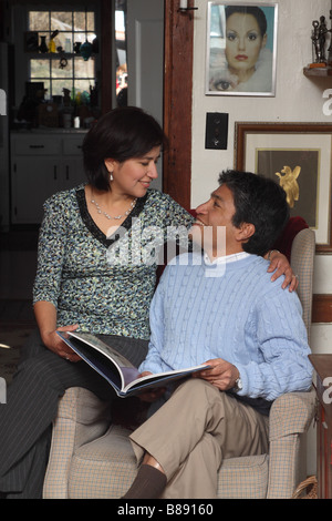 happy Hispanic couple reading book and posing Stock Photo