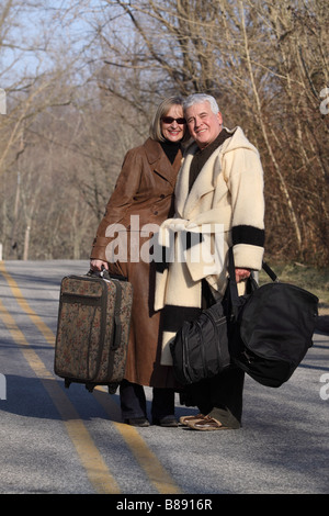 fashionable senior couple in the winter with luggage traveling Stock Photo