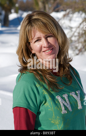 Young woman enjoying a fresh snow fall Stock Photo