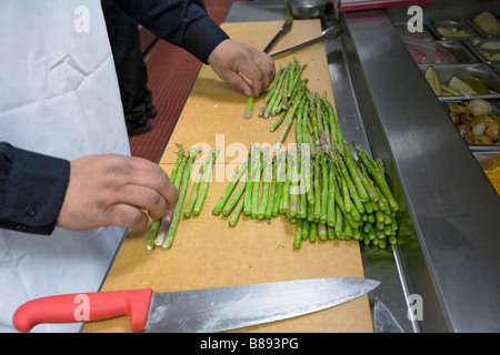 Detroit Michigan A worker slices asparagus in the kitchen of the Greektown Casino Hotel Stock Photo