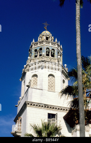 Church bell tower with palm trees and lamps Stock Photo