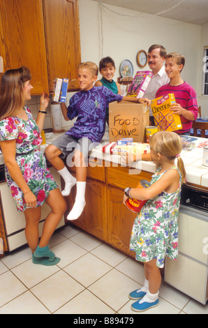 Family gathers items for church food drive Stock Photo