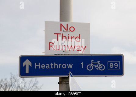 A 'No Third Runway' protest sign and a 'Heathrow' direction sign on the edge of Sipson, site of Heathrow's proposed third runway Stock Photo