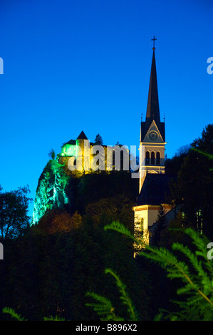The St Martin s Parish Church and Castle illuminated at night in Bled Slovenia Stock Photo