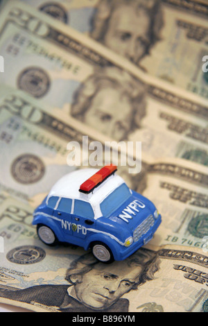 NYPD toy police car and twenty dollar bills Stock Photo