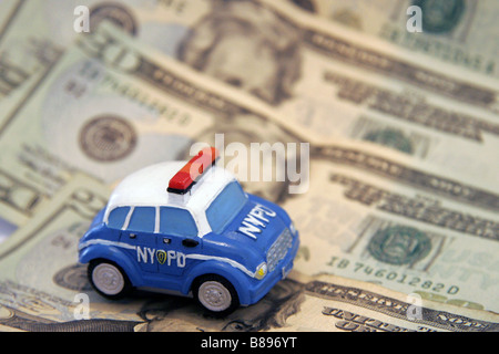 Toy NYPD police car and twenty dollar bills Stock Photo