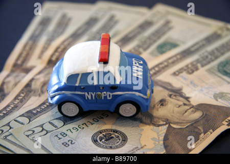 Toy NYPD police car and twenty dollar bills Stock Photo