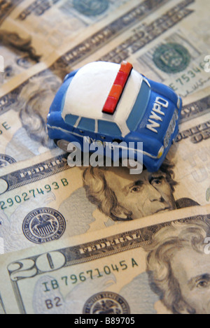 Toy NYPD police car and twenty dollar bills Stock Photo