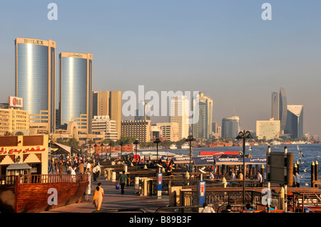 Dubai Deira side of the Creek at the Deira Old Souk waterbus station with Royex towers and city skyline beyond Stock Photo