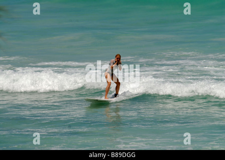 A wonderful beach of Barbados with a surfer Caribbean Stock Photo