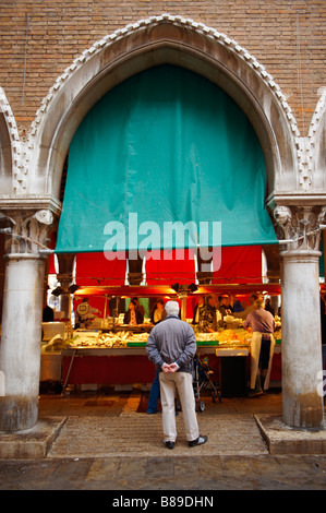 Venetians buying fresh fish in the Rialto market, Venice Stock Photo