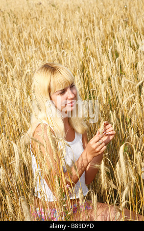 Young woman in the rye meadow Stock Photo