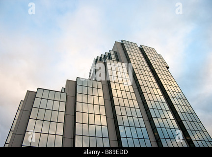 Sky and clouds reflected on a glass fronted office block in Glasgow Stock Photo