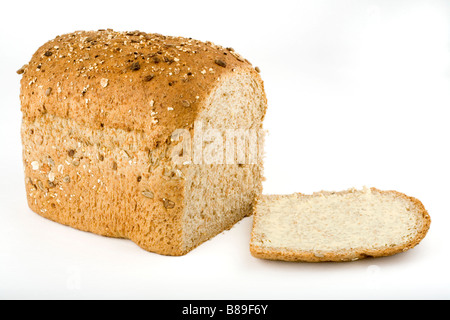 A loaf of wholemeal multi-grain bread and buttered slice Stock Photo
