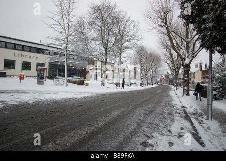 library Highams Park with snow and slush in road Stock Photo