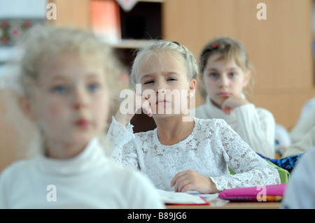 A schoolgirl focusing on her studies in a primary school classroom. Stock Photo