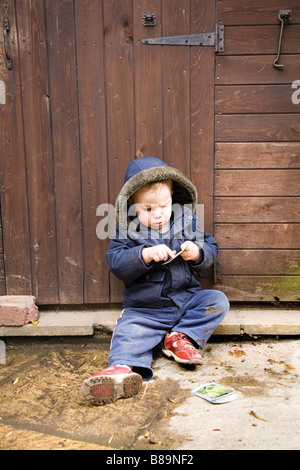 Boy playing on shed's step Stock Photo: 22339511 - Alamy